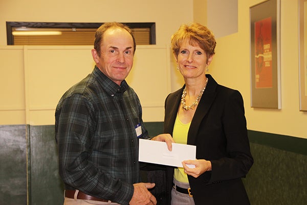 Bruce Ness from Pelican Breeze Foundation accepts a donation from Jill Peterson, chairwoman of the Freeborn County Community Foundation. -Provided