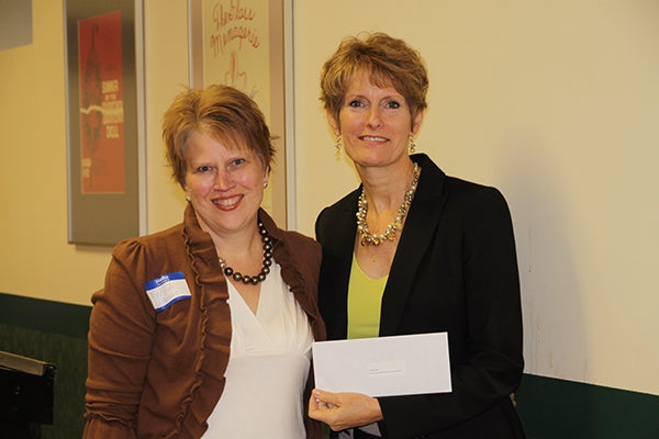 Mary Jo Volkman of Community Mentor Connections/STARS Mentoring accepts a donation from Jillian Peterson, board chairwoman of the Freeborn County Community Foundation. - Provided