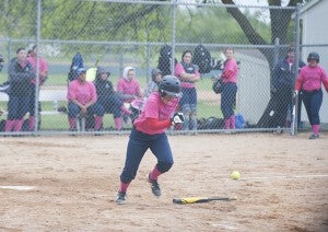 Tigers shortstop Dayna Edwards attempts to beat out a bunt attempt in the third inning Thursday.