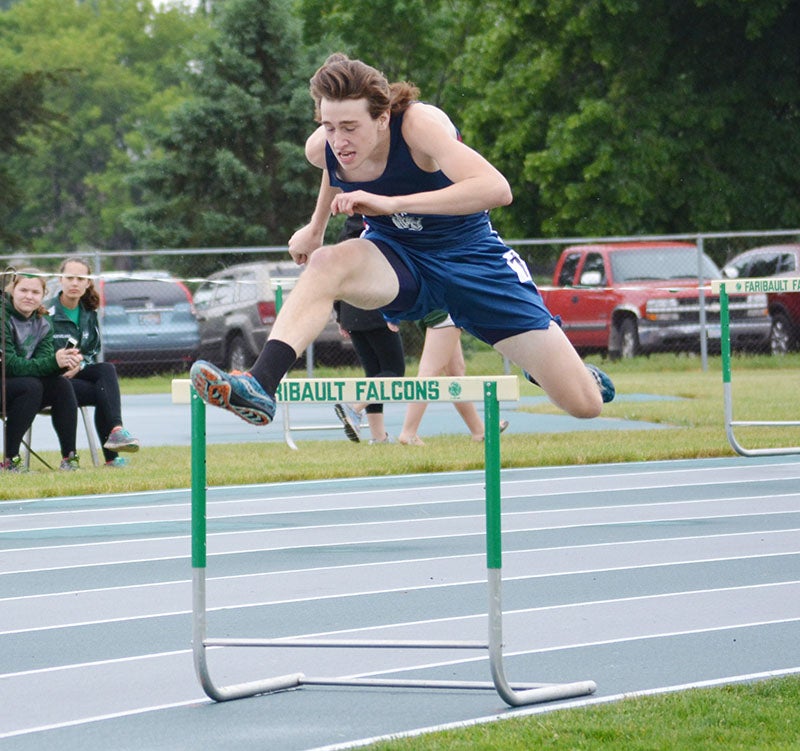 Albert Lea’s Abe Peterson clears a hurdle during the 300-meter hurdle race at the Big Nine Conference track and field championships at Ted Nelson Track in Faribault on Friday. Peterson finished took eighth in the event for the Tigers. Lon Nelson/ For the Albert Lea Tribune