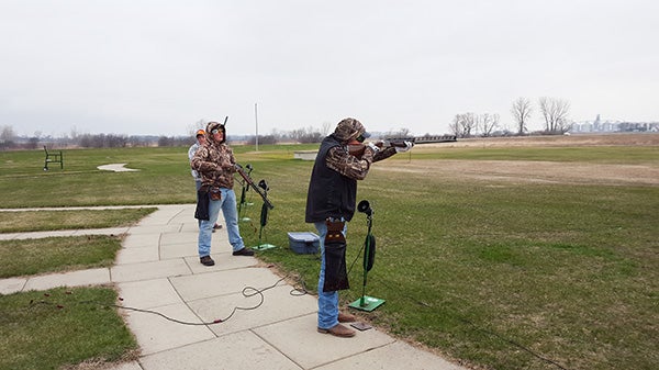 NRHEG’s Collin Christiansen takes aim while Kyle Bartz looks on. Both shooters have been top shooters on the clay target team and are hoping to make return trips this year to the Minnesota State High School League state individual tournament after missing qualification last season. - Provided