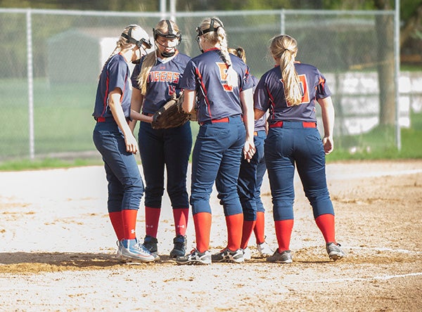 The Albert Lea softball team meets in the circle during Monday's game against Kasson-Mantorville at Hammer Field. -  Jarrod Peterson/Albert Lea Tribune