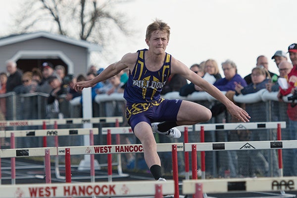 A Lake Mills runner competes in a hurdles event Monday at West Hancock. - Lory Groe/For the Albert Lea Tribune