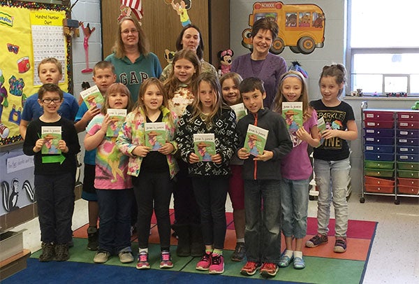 The Glenville Area Women of Today donated books to the Glenville-Emmons second-grade class. Members presenting books are Brenda Bangs, Sarah Johnson and Sherry Adams. - Provided