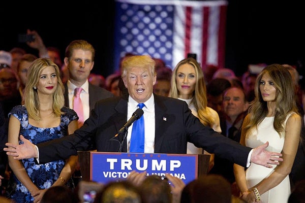 Republican presidential candidate Donald Trump is joined by his wife Melania, right, daughter Ivanka, left, and son Eric, background left, as he speaks during a primary night news conference on Tuesday. - Mary Altaffer/AP
