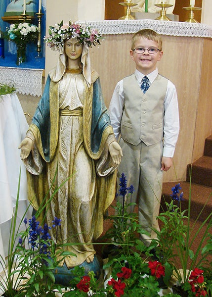 The students of St. Casimir’s School in Wells recently participated in this time-honored Church tradition of May Crowning. During this devotion, all of the children placed flowers at the feet of the school’s statue of Mary on Mother’s Day. Following the procession of flowers to the altar, second-grade student Michael Oldham received the honor of placing a crown of flowers upon Mary’s head. - Provided