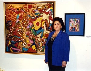 Merna Sunde stands next to some of her artwork during a show at The Albert Lea Center in the 1990s. - Provided