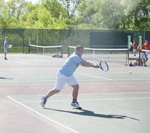 Albert Lea’s Schafer Overgaard returns a serve made by his opponent during his match Tuesday. Overgaard won his match 6-2, 7-5 to help the Tigers advance to the second round of the section tournament.