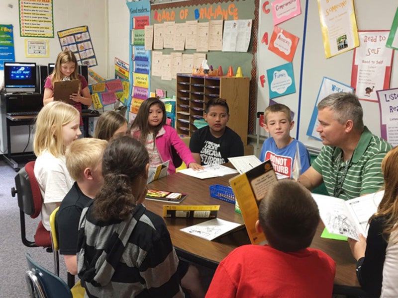 Lilyona Valdez, as principal for the day, grades Albert Lea Area Schools Superintendent Mike Funk while he teaches a class Tuesday at Hawthorne Elemenetary School. -Provided