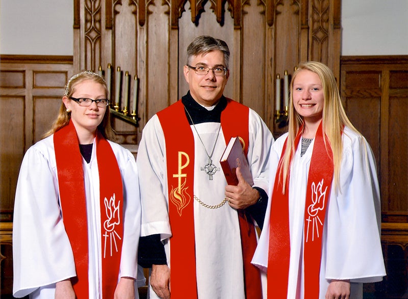 Holly Stene and Katie Cliff were confirmed in the Lutheran faith May 15 at Hartland Evangelical Lutheran Church. Pictured, from left, are Stene, the Rev. Shawn Stafford and Cliff. - Provided
