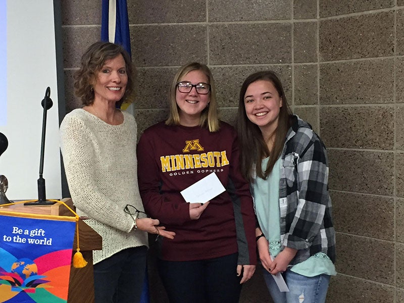 Rotary President Sheila Schulz presents scholarships of $500 each to Carissa Fitzlaff and Anna Waltman after completion of their first semester of college. Fitzlaff attends the University of Minnesota and Waltman attends the University of Wisconsin Eau Claire. -Provided
