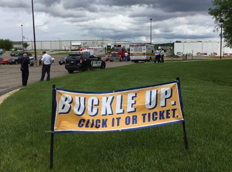 Local police officers and ambulance crew members reminded Albert Lea High School students to buckle up before the school year ended by passing out bracelets to students as they left school for the day. The bracelets were imprinted with the messsage, “Always buckle up.” - Provided