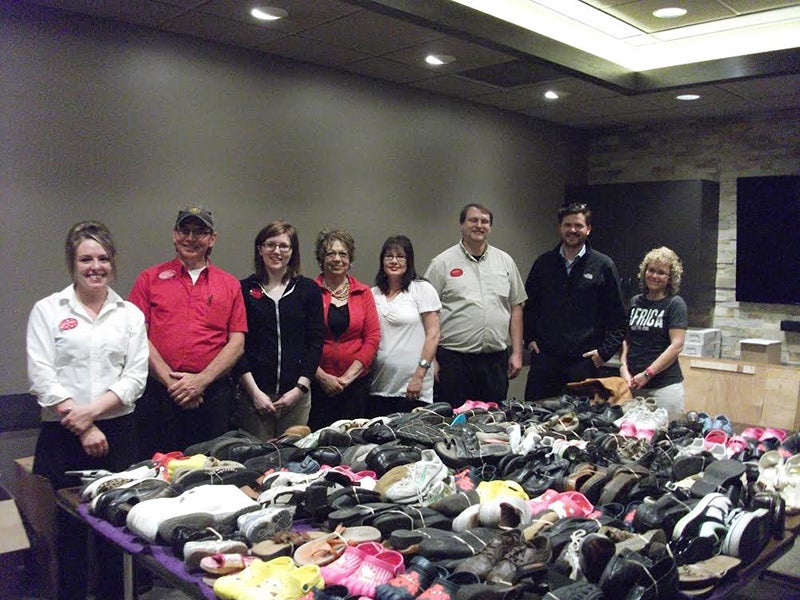 Trail’s Travel Center employees presented 120 pairs of donated shoes for the Soles for Jesus mission project that Laurie Neff, far right,  headed up in the area. Trail’s Travel Center employees pictured, from left, include Melanie Cibert, Trent Gorton, Chelsea Poplow, Rhonda Burgess, Deb Morgan, Jason Amundson and Dustin Trail. - Provided