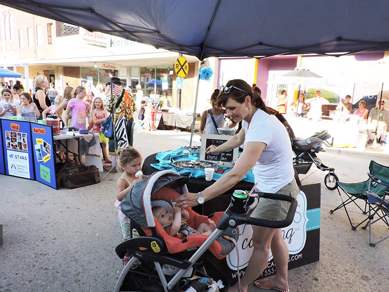 A portion of Broadway in Wells was blocked off for Summer in the City from 4 to 7 p.m. Thursday. The first time event was similiar to Albert Lea’s Wind Down Wednesday and featured games, vendors and business tables, including a S’more making station by Lacey’s Catering. - Kelly Wassenberg/Albert Lea Tribune