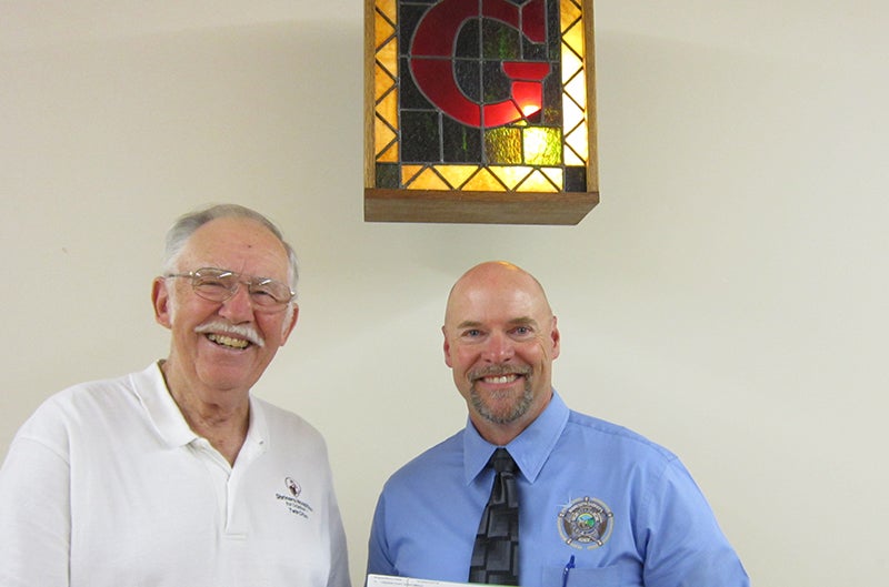Jake Loper of Western Star Lodge No. 26 presents a $100 donation from Minnesota Masonic Charities to Freeborn County Sheriff Kurt Freitag for the sheriff’s K-9 fundraiser. - Provided