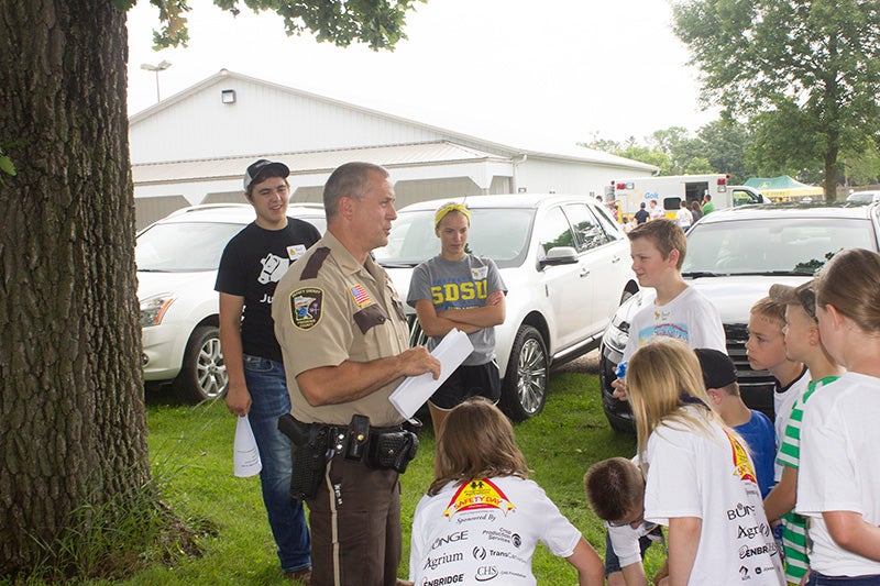 Freeborn County Sheriff’s Office Patrol Deputy Dale Glazier instructs local youth on safety measures Wednesday at Freeborn County Fairgrounds. - Sam Wilmes/Albert Lea Tribune