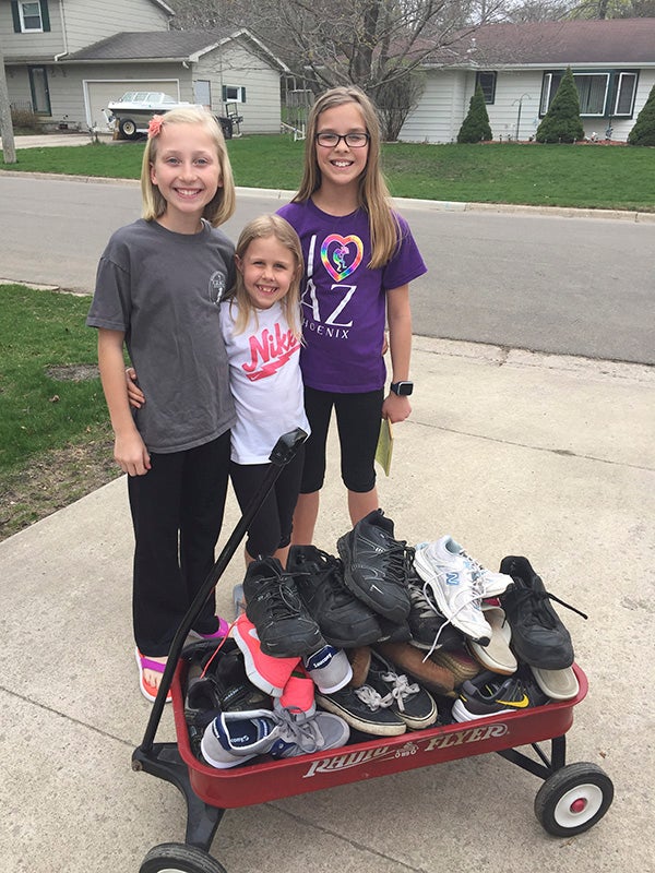 Gracie Palmer, Taylor Klocke and Kaitlyn Klocke recently collected  several dozen shoes for the Humane Society of Freeborn County by walking through their neighborhood near Sibley Elementary, knocking on doors and using their red wagon to carry them home. -Provided