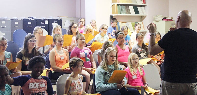Tim O’Shields, minister of music and worship at First Lutheran Church, directs the youngest age group in one of the music school’s daily practices. - Henry Rohlf/Albert Lea Tribune