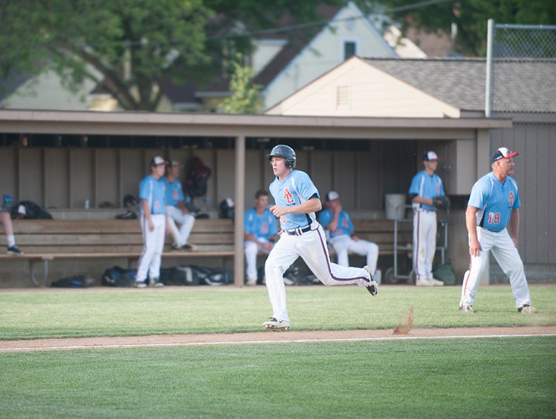 Albert Lea’s Ben Witham heads for home in the first inning on an RBI single by Jake Kilby. 
