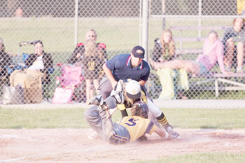 Lake Mills’ Luke Groe does his best to beat the tag at home plate, but was thrown out during Thursday’s game against Clear Lake.