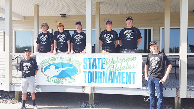 From left, Tory Christenson, Zachary Eustice, Alex Romer, Noah Lund, Collin Christenson, Kyle Bartz and Tanner Alfson pose in front of the Minnesota State High School League state banner Saturday. The NRHEG team ended up with a fourth place finish in the state tournament. Provided