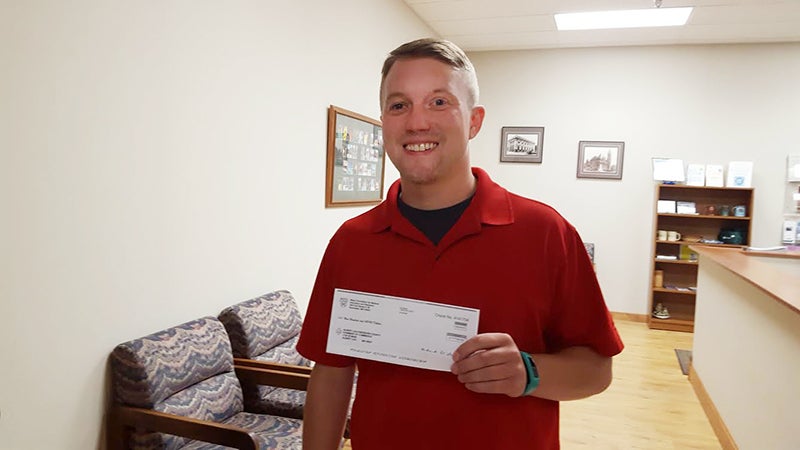 Paul Shea accepts a $900 donation from Mayo Clinic Health System in Albert Lea for the Cellfie tours. - Provided