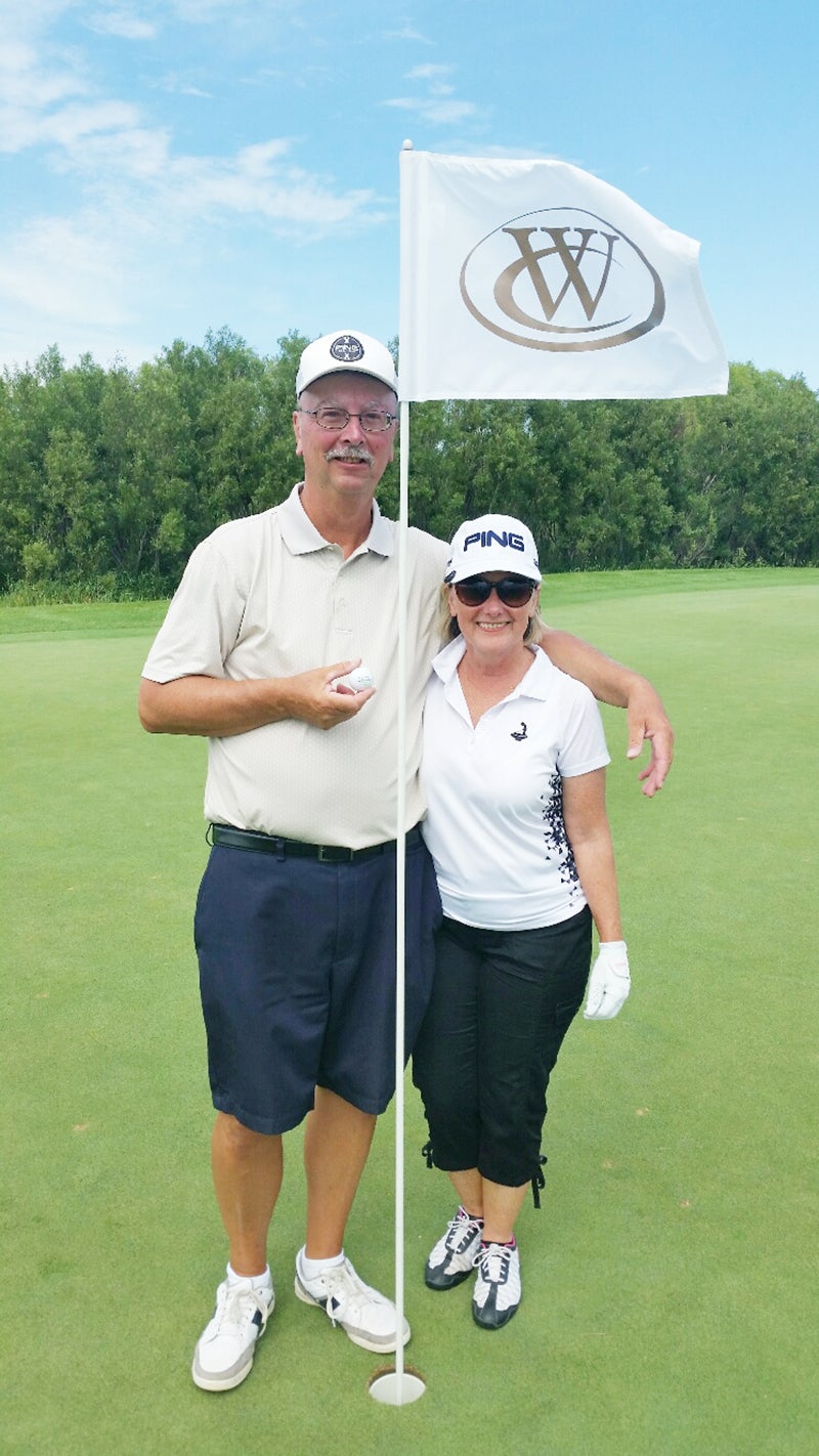John Krieger, with his wife, scored an ace on hole No. 17 at Wedgewood Cover Golf Club on Sunday during a couples’ event. Provided