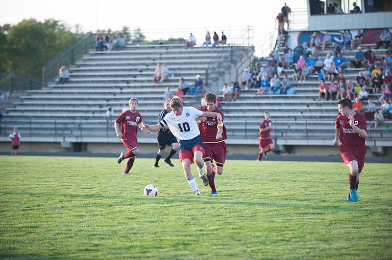 Albert Lea’s Sam Ehrhardt (10) holds off Stewartville’s Alex Vande Loo to gain possession of the ball in the first half Monday. Ehrhardt had one goal and one assist in the Tigers’ win.