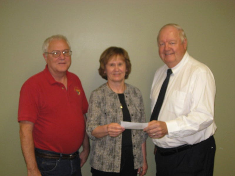 Albert Lea Knights of Columbus representatives Bob Donovan, left, and Gerry Gehling, right, presented a second donation from its Tootsie Roll Drive to The Arc of Freeborn County representative Jo Lowe, center. -Provided