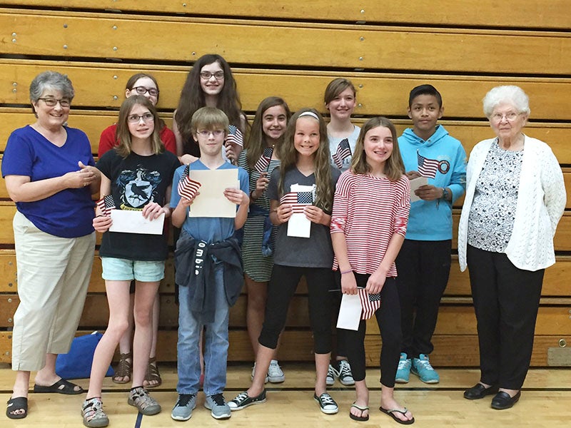 Students competing in the Patriot’s Pen Contest include, first row, Ava Corey-Gruenes, Brennan McCalla — local first-place winner and third-place winner at the district level,  Malana Thompson and Jenna Steffl. Second row, Samantha  Brumbaugh, Adriana Brumbaugh, Yamir Sok Amador, Vayda Stadheim and Taylor Palmer. Also pictured with them are Marilyn Danielsen of the Freemond Madsen VFW Auxilliary youth Chairwoman; and  Marcie Peterson, VFW Auxiliary No. 447 representative. The theme for 2016-17’s contest is “The America I Believe in.” The essay contest encourages young minds to examine their own experiences in modern American society. For more information, contact Danielsen at 507-402-7080. Essays are due Nov. 1. -Provided