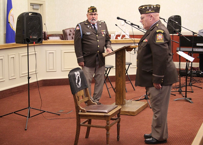 Tim Donahue, right, leads the audience in a moment of silence for soldiers who were prisoners of war or missing in action during the Veterans Day ceremony Friday at the Freeborn County courthouse. - Sarah Stultz/Albert Lea Tribune