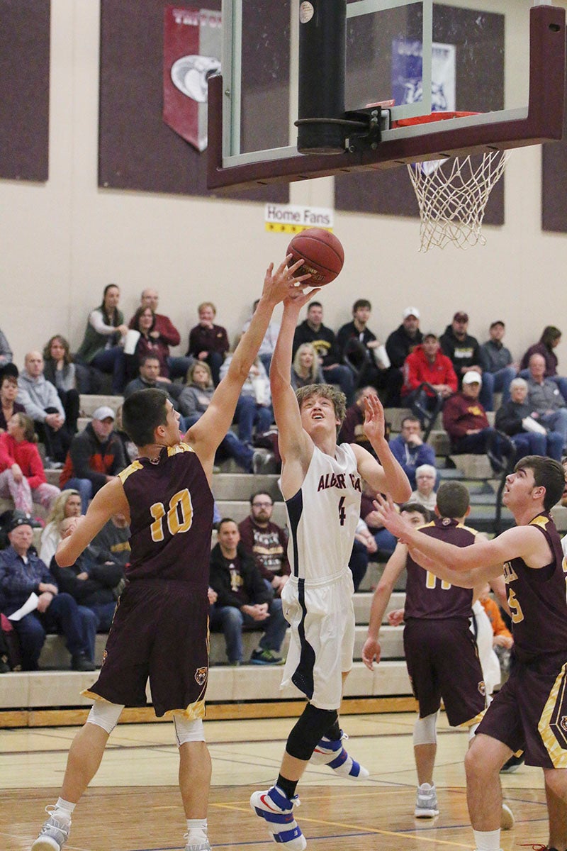 Albert Lea’s Jack Buendorf goes up for a layup against Stewartville’s Carter Groski during a game Thursday night in Stewartville. Albert Lea lost 54-35. Provided