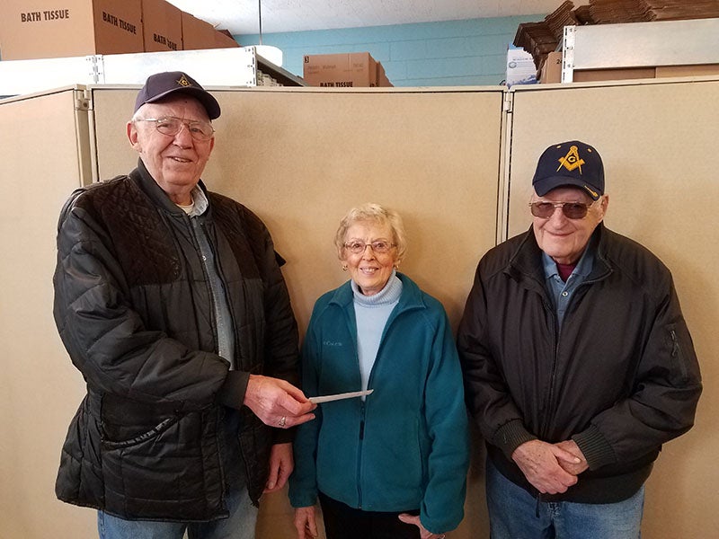Jake Loper, left, and Bob Hahn, right, present a $500 donation to the Ecumenical Food Pantry of Albert Lea on the behalf of the Masonic Lodge of Albert Lea. - Provided