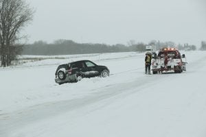 A vehicle is pulled out of the ditch on southbound Interstate 35 Friday morning. Sarah Stultz/Albert Lea Tribune
