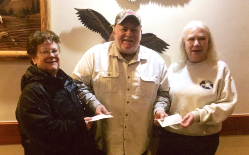 A representative from the Eagles Club Texas Hold ‘em presents donations to representatives from The Salvation Army and Humane Society of Freeborn County for $300 each. - Provided